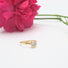 A diamond solitaire ring in 14 karat yellow gold with prong and bezel set diamond on a fine textured band.