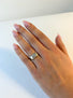 On almost square-like band sits an antique cushion cut diamond in a unique bezel setting.