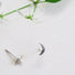 Tiny Pair of crescent shaped stud earring featuring a small 2 mm white round pearl in the centre of the crescent.
