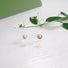 Tiny bowl shaped studs detailed with textured silvers rims.  A 4 mm white pearl sits in the centre of the  bowl.