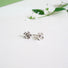 A five petal flower stud earring. Hand textured petals and silver balls in the centre of the flower to resemble stamens.