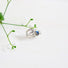 A striking sterling silver ring with an Art Deco feel. Vines and leaves intertwine around the finger to create the band This ring is highlighted with an iridescent blue green 6 mm Labradorite gemstone set in sterling silver.