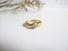 A gold solitaire diamond ring. Hand engraved with scrolls, leaves and flowers in Victorian Style
