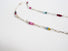 Authentic gemstones: Blue topaz, Garnets, Rhodolite garnets. Rubies  Sapphires and genuine pearls are arranged in an artful and asymmetrical design on a sterling silver paper clip link chain
