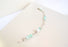 A silver link bracelet showcases light green coloured Peruvian Opal beads and genuine fresh water pearls.