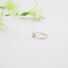 side view of a diamond solitaire with prong and bezel setting on a fine textured band.