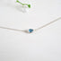 A 3 x 5 mm pear Shaped London Blue Topaz is set in a horizontal position on a fine 16" sterling silver chain.