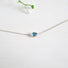 A 3 x 5 mm pear Shaped London Blue Topaz is set in a horizontal position on a fine 16" sterling silver chain.