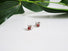 Silver post earrings with genuine red garnets stones and a pearl are nestled between the V leaf shaped design.P