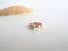 A 3 mm rose gold band with a white gold diamond setting