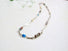 A link necklace made of paperclip and rolo style silver links,: apatite, tourmaline, black pearls, moonstone, smokey topaz beads