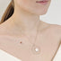Model wears a handcrafted pendant with an open circle with a white coin pearl attached to the bottom inside of the circle.