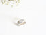 On almost square-like band sits an antique cushion cut diamond in a unique bezel setting.