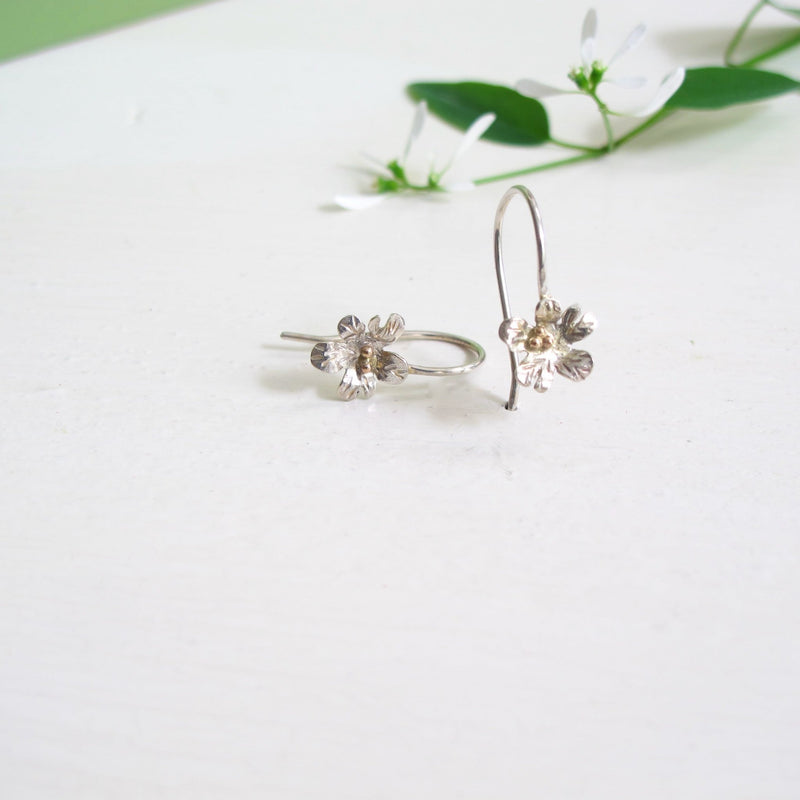 5 petal silver handcrafted daisy earring with ear hooks.  The centre of each flower are round yellow gold balls to resemble stamens. 