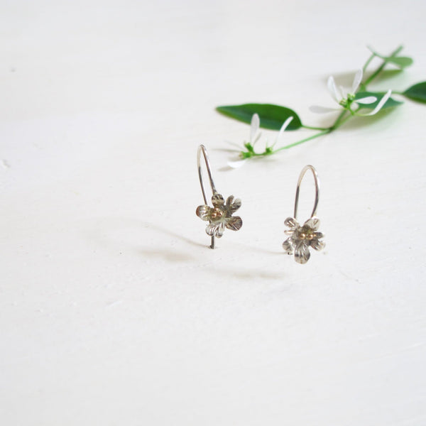 5 petal silver handcrafted daisy earring with ear hooks.  The centre of each flower are round yellow gold balls to resemble stamens. 