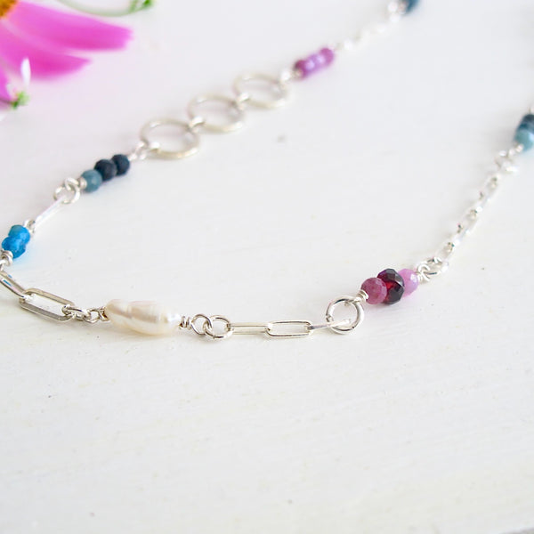 A  16 " Silver paper clip  link necklace studded with 3 mm genuine gemstones: beads of  Sapphires, Rhodolite Garnets, Apatite, Genuine Freshwater Cultured Pearls.

