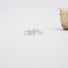 Two textured bands in silver  lie on a white surface.  Both bands are textured  to resemble birchbark.