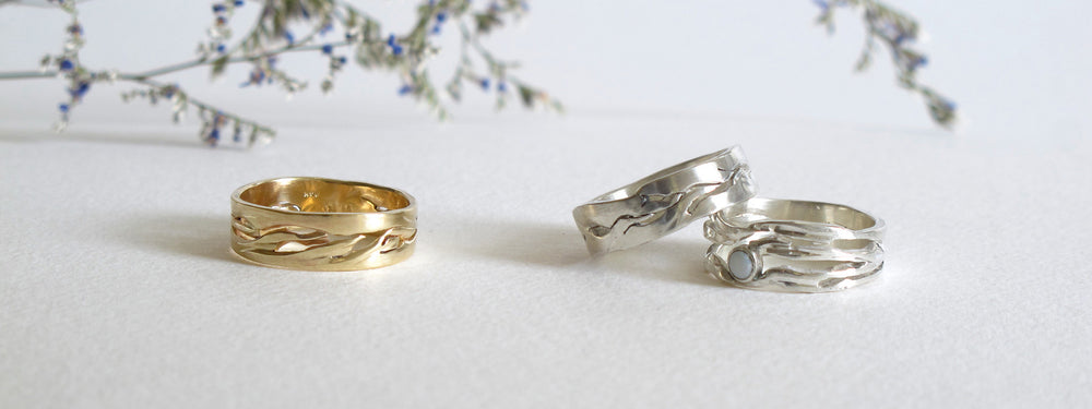 custom made rings with cutout forms that resemble water flowing down a river