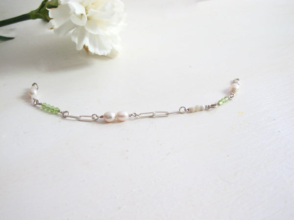 A Link bracelet composed of  silver Paperclip chain and 3 mm gemstone beads: Apple Green Peridot, White Pearls, White Moonstone. Length 7.50 " with lobster clasp/