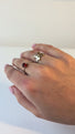 Woman wears a golden butterfly ring. She is moving her hand around to show of all sides of the butterfly ring