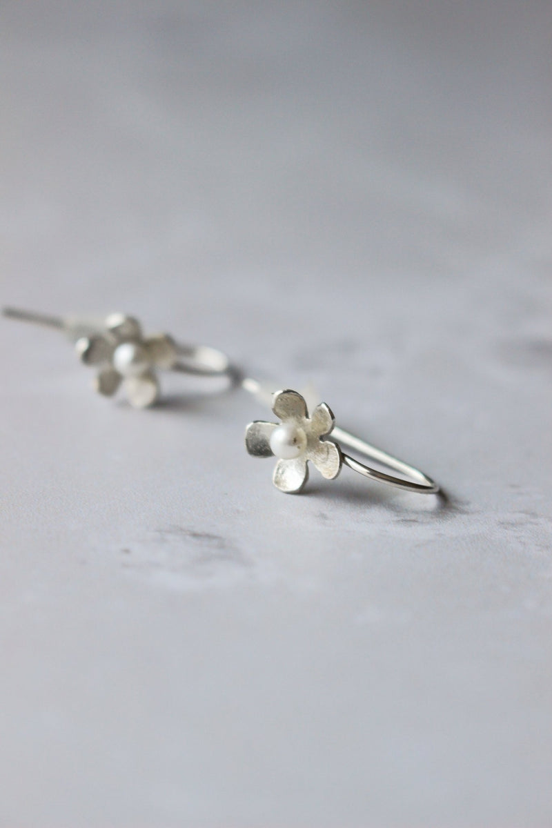 5 petal silver handcrafted daisy earring. In the centre of each flower is a reiki imbued small 3 mm round white pearl.