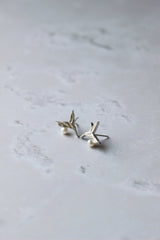 A 10 mm tiny silver hummingbird stud with a small white pearl placed at the bottom of the bird's breast.