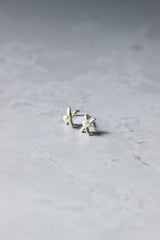 A small pair of reiki imbued stud X's with a small consciously sourced pearl in the middle of the X.