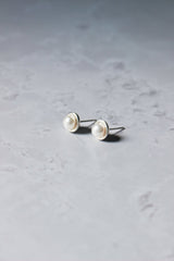 White pearl studs  The pearls nestle into a Reiki imbued halo of silver handcrafted to sit snugly to the earlobe.